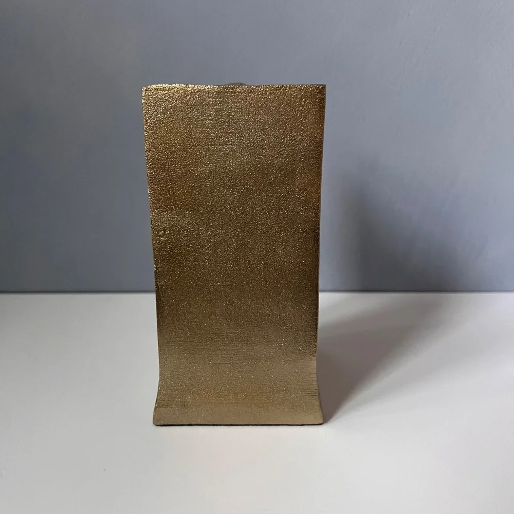 West Elm sculptural bookend in textured antique gold finish.